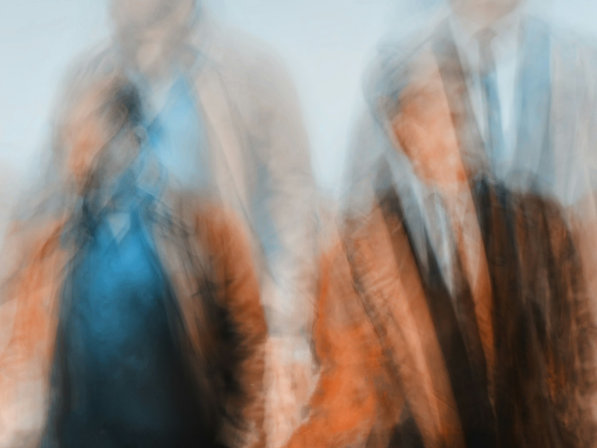 Blurred silhouettes in motion, in orange and blue light